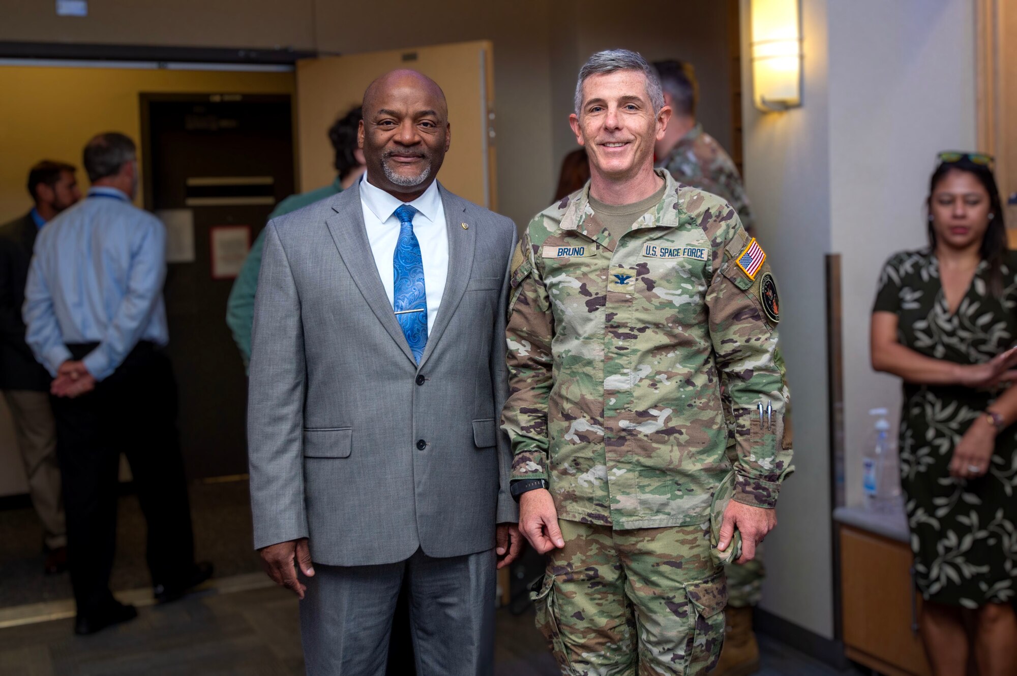 two men pose for a photo