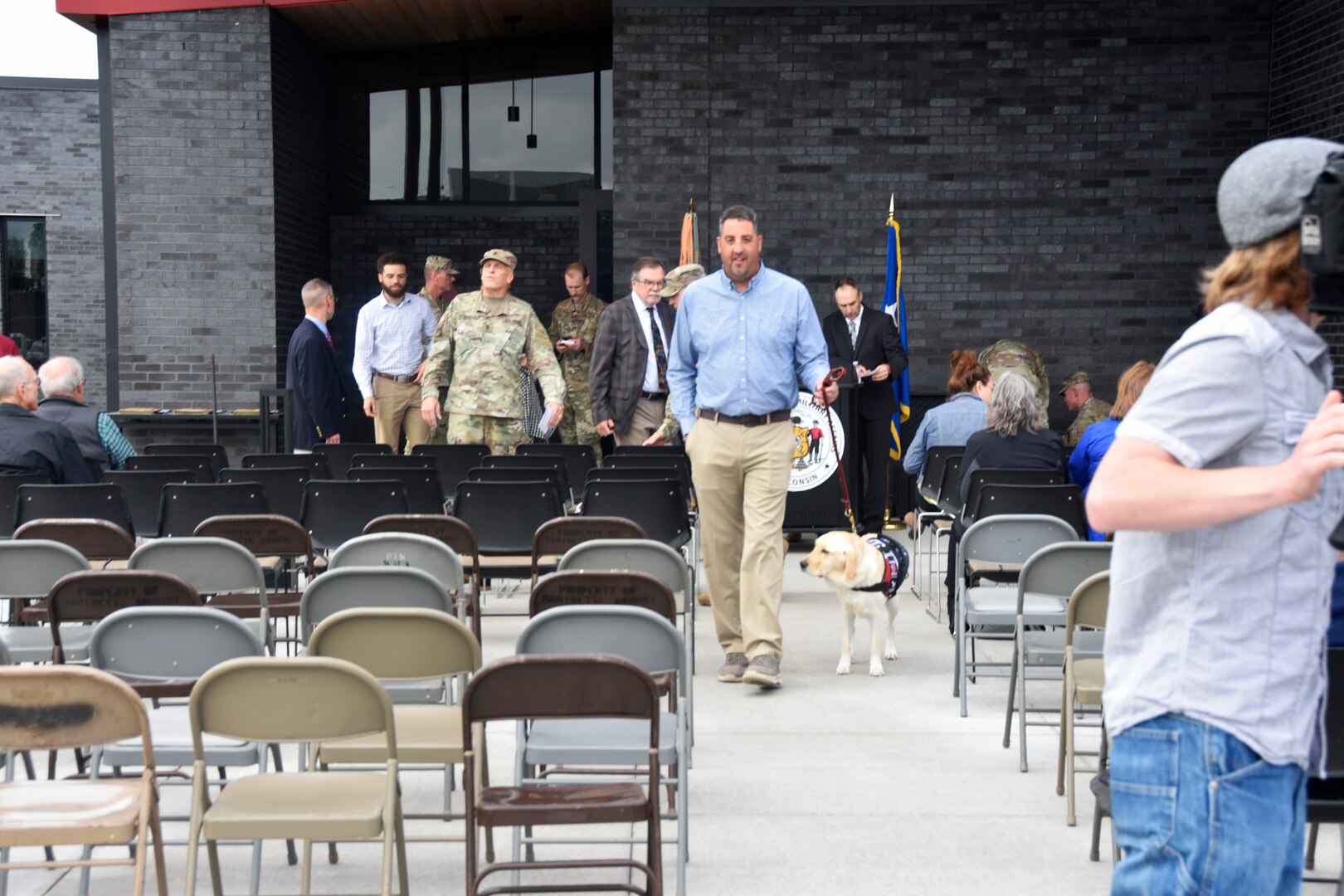 Jay Wilson, a retired lieutenant colonel with the Wisconsin Army National Guard, and his service dog Frosty at the grand opening for the $15 million renovation of the armory in Appleton, Wis. Wilson is an engineer with the Wisconsin Department of Military Affairs, and his office was involved in this construction project. Wisconsin Department of Military Affairs photo by Vaughn R. Larson