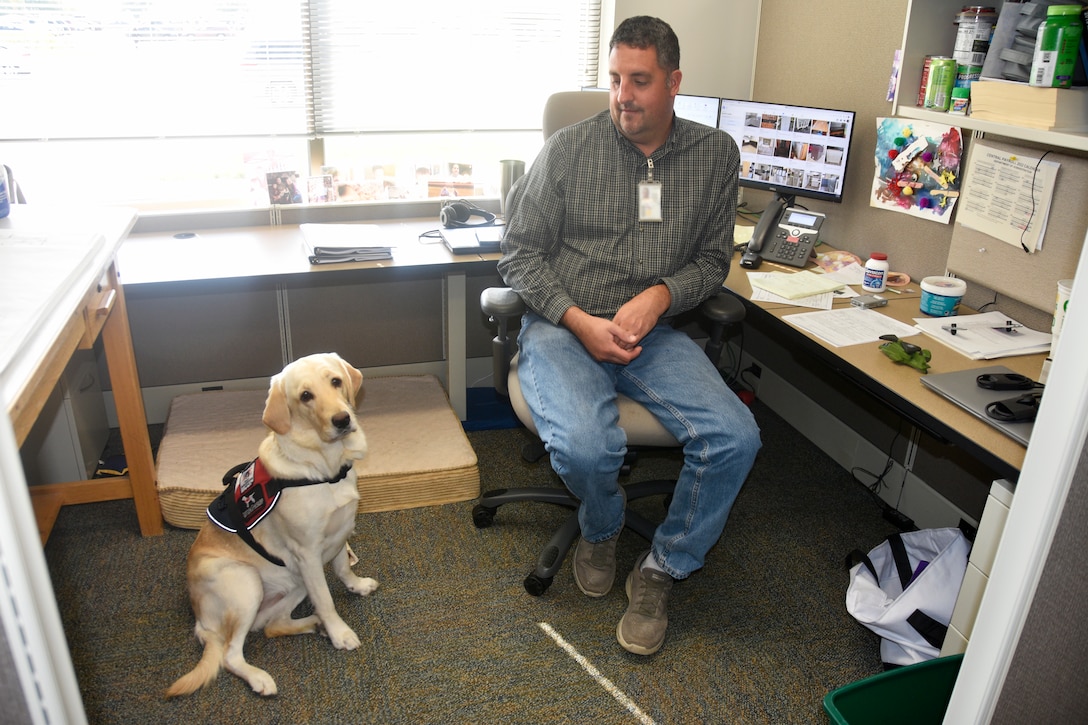 Jay Wilson, a retired lieutenant colonel with the Wisconsin Army National Guard, and his service dog Frosty at his office in the Wisconsin Department of Military Affairs in Madison, Wis., where he works as an engineer.