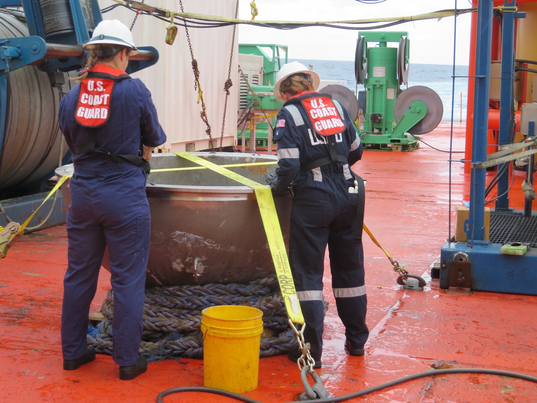 Coast Guard marine safety engineers assigned to the Marine Safety Center in Washington D.C., working for the Marine Board of Investigation for the Titan submersible case, conduct a survey of the aft titanium endcap from Titan in the North Atlantic Ocean Oct. 1, 2023.