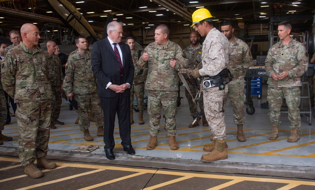 SECAF watches as an Airman in training puts on his equipment for climbing the communication poles.