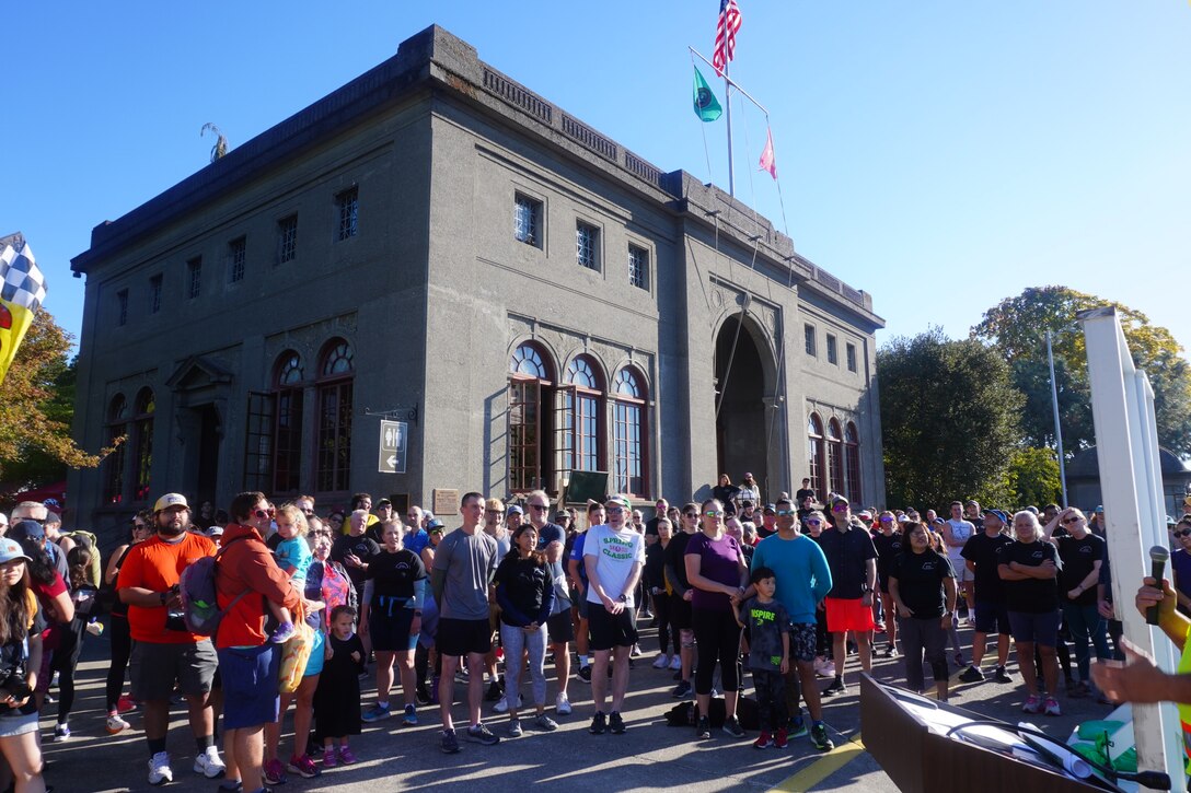 A crowd of participants listen for the buzzer to start their fun run along Lake Washington Ship Canal and Hiram M. Chittenden Locks, Seattle, Washington.