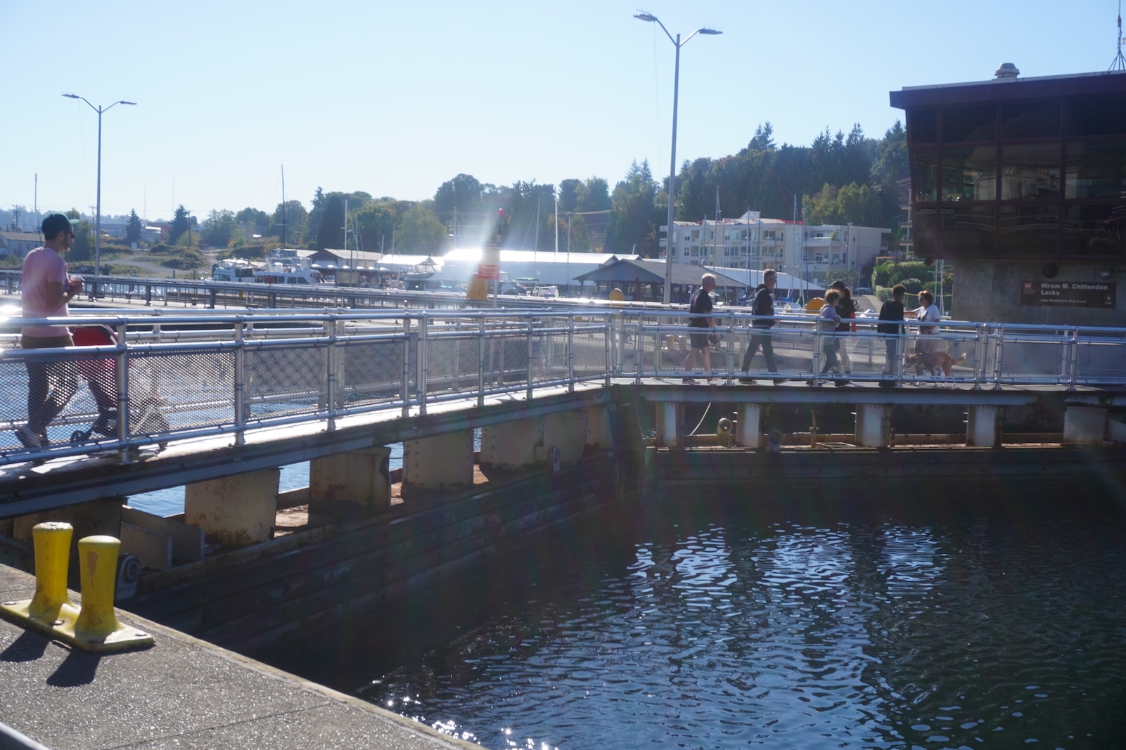 Visitors walking across the large lock at Lake Washington Ship Canal and Hiram M. Chittenden Locks, Seattle, Washington.