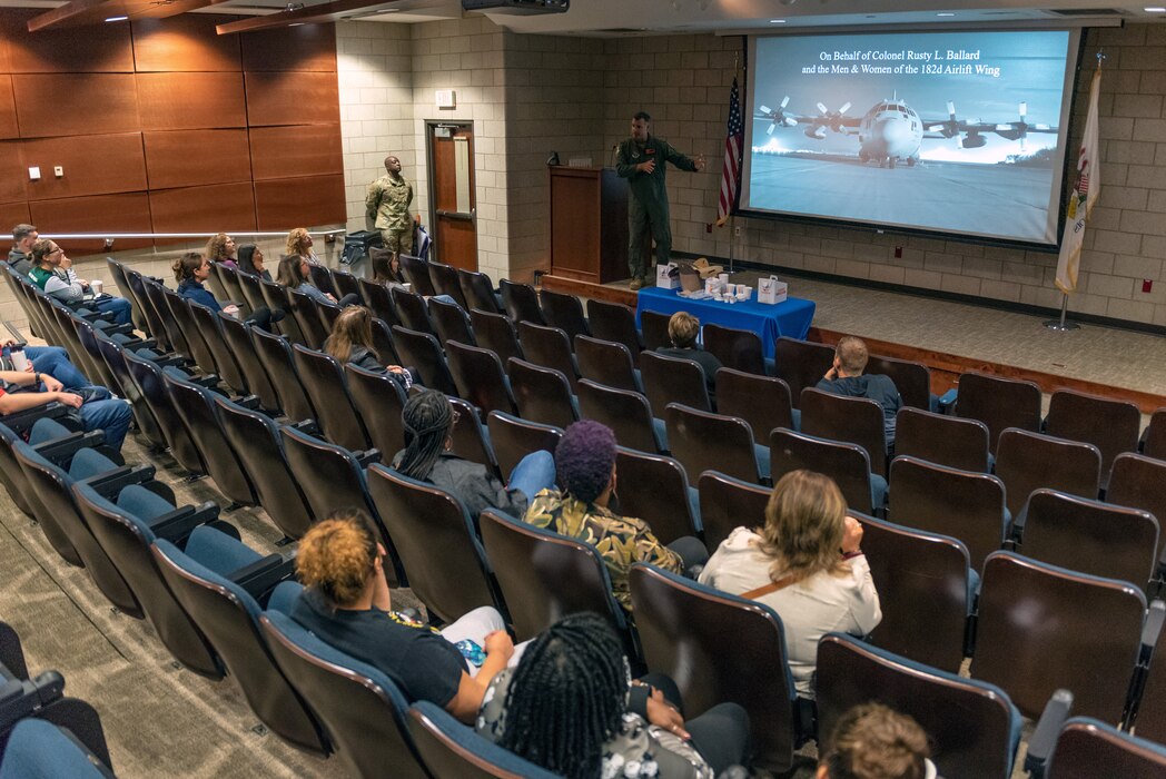 Civilians learn about military operations during a tour.