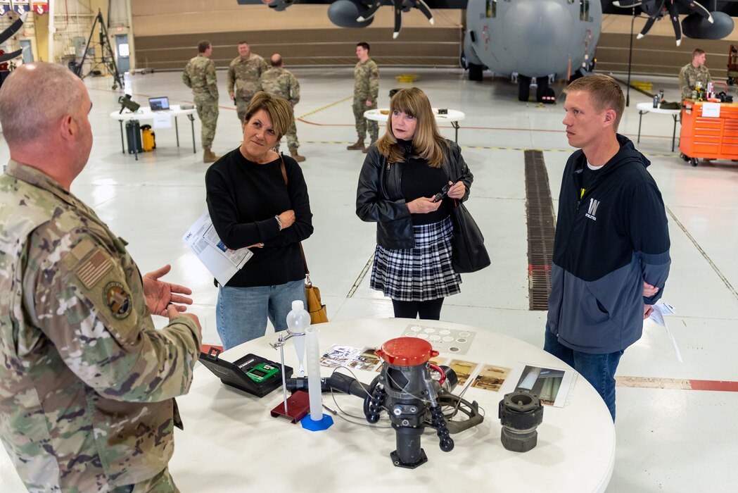 Civilians learn about military operations during a tour.