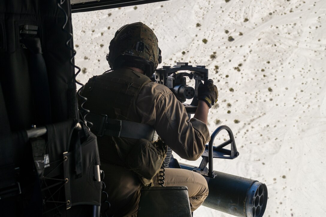 U.S. Marine Corps Staff Sgt. Nicholas Prince, a weapons and tactics instructor with Marine Light Attack Helicopter Squadron (HMLA) 773, 4th Marine Aircraft Wing, conducts live fire shooting drills in a UH-1Y Venom Huey during Integrated Training Exercise (ITX) 4-23 at Marine Corps Air Ground Combat Center, Twentynine Palms, California on June 25, 2023. As the Marine Corps Reserve’s premier annual training event, ITX provides opportunities to mobilize geographically dispersed forces for a deployment; increase combat readiness and lethality; and exercise MAGTF command and control of battalions and squadrons across the full spectrum of warfare. Prince is an active duty Marine and native of Victoria, Texas. He graduated from Gila Ridge High School. (U.S. Marine Corps photo by. Cpl. Ryan Schmid)