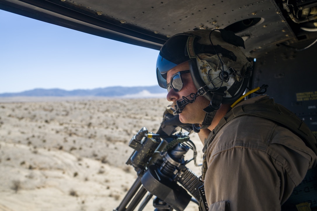 U.S. Marine Corps Staff Sgt. Keith Lohoefer, a weapons and tactics instructor with Marine Light Attack Helicopter Squadron (HMLA) 773, 4th Marine Aircraft Wing, Marine Forces Reserve checks his surrounding before conducting live fire shooting drills in a UH-1Y Venom Huey during Marine Forces Reserve during Integrated Training Exercise (ITX) 4-23 at Marine Corps Air Ground Combat Center, Twentynine Palms, California on June 25, 2023. As the Marine Corps Reserve’s premier annual training event, ITX provides opportunities to mobilize geographically dispersed forces for a deployment; increase combat readiness and lethality; and exercise MAGTF command and control of battalions and squadrons across the full spectrum of warfare. Lohoefer is an active duty Marine and native of Woodbine, Maryland where he graduated from South Carroll high school. (U.S. Marine Corps photo by. Cpl. Ryan Schmid)