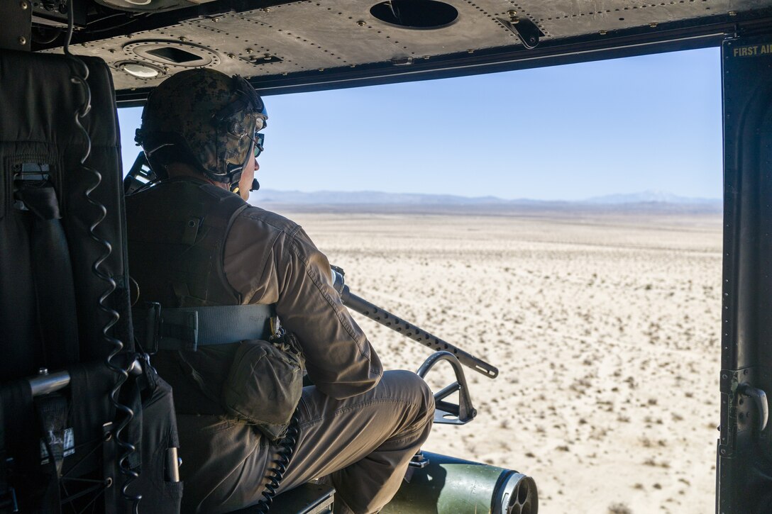 U.S. Marine Corps Staff Sgt. Nicholas Prince, a weapons and tactics instructor with Marine Light Attack Helicopter Squadron (HMLA) 773, 4th Marine Aircraft Wing, Marine Forces Reserve, checks his surrounding before conducting live fire shooting drills in a UH-1Y Venom Huey during Integrated Training Exercise (ITX) 4-23 at Marine Corps Air Ground Combat Center, Twentynine Palms, California on June 25, 2023. As the Marine Corps Reserve’s premier annual training event, ITX provides opportunities to mobilize geographically dispersed forces for a deployment; increase combat readiness and lethality; and exercise MAGTF command and control of battalions and squadrons across the full spectrum of warfare. Prince is an active duty Marine and native of Victoria, Texas. He graduated from Gila Ridge High School. (U.S. Marine Corps photo by. Cpl. Ryan Schmid)