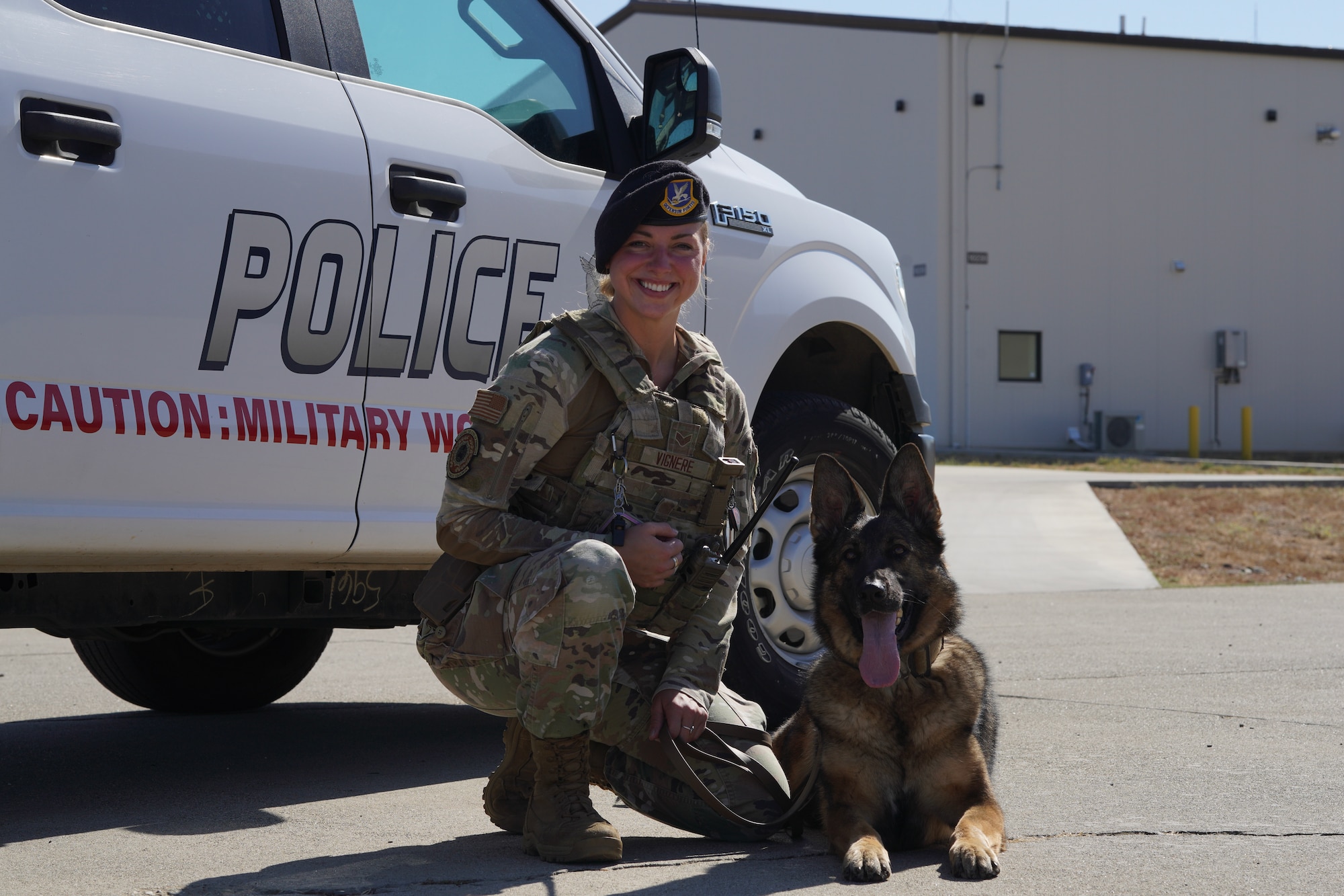U.S. Air Force Senior Airman Kiersten Vignere, 9th Security Forces Squadron military working dog handler, and Sofi, 9th SFS military working dog, pose for a photo after conducting explosive detection training Sept. 14, 2023, at Beale Air Force Base, California.