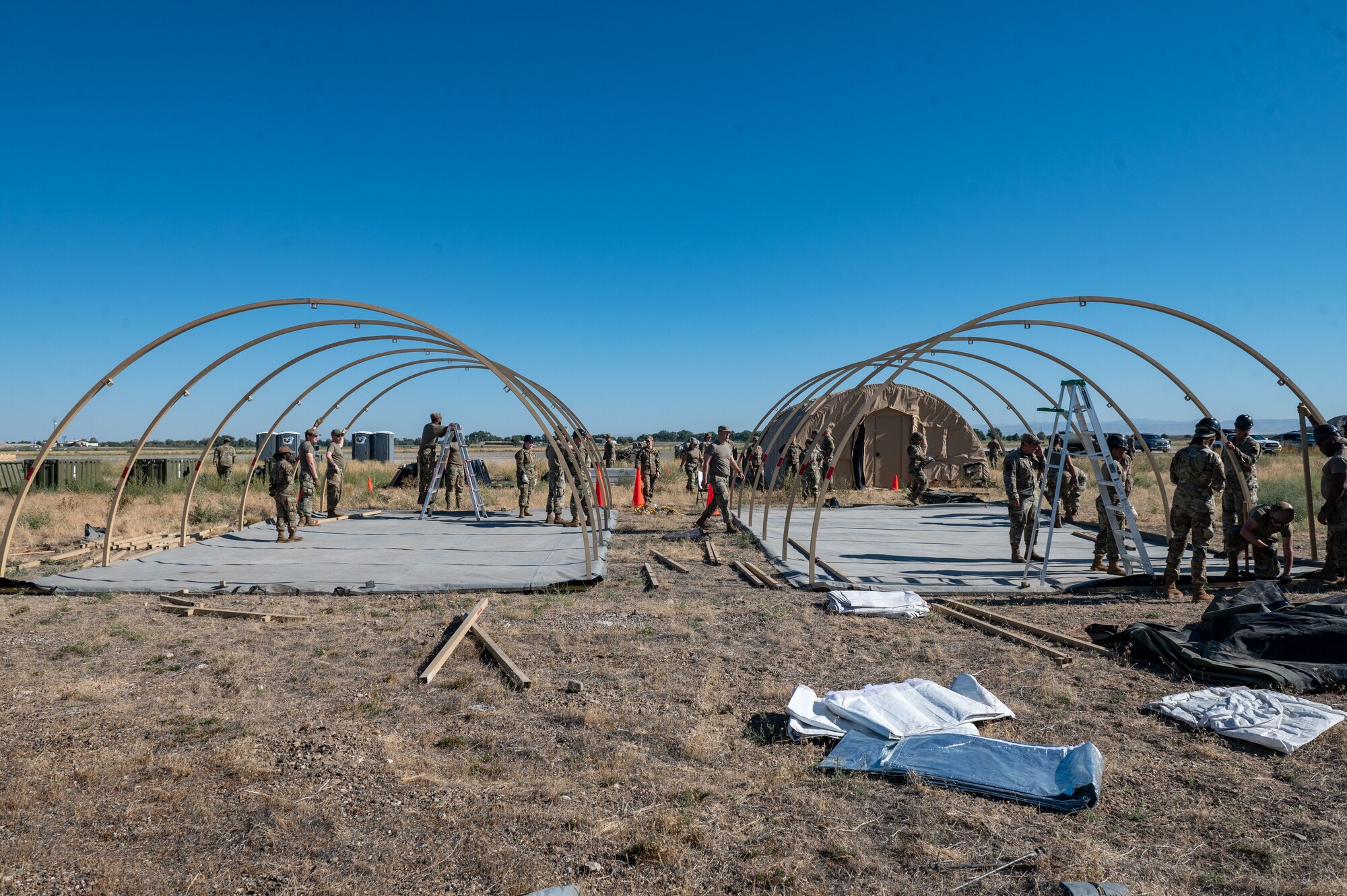 Airmen assemble tents.