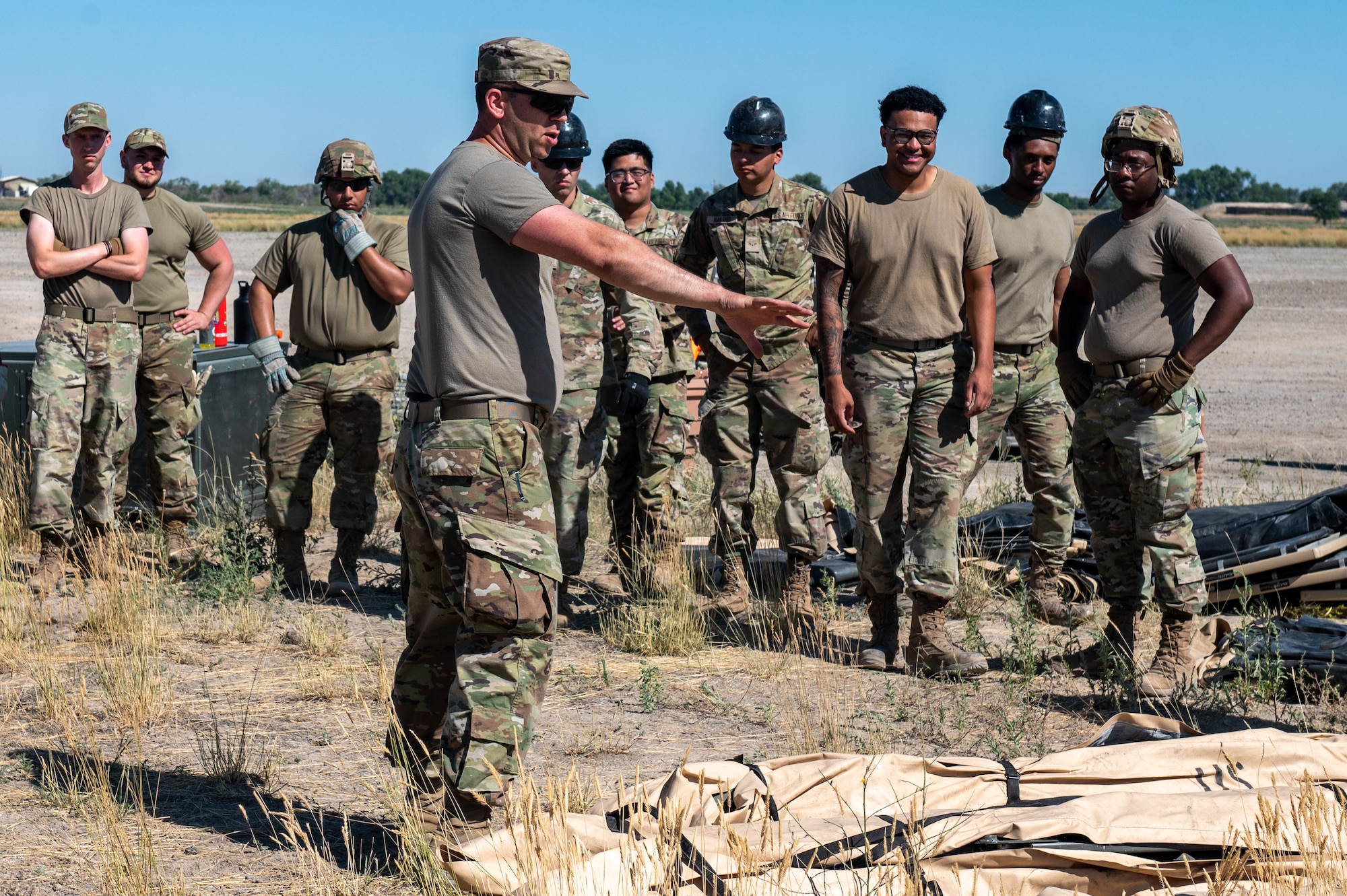 A sergeant instructs Airmen on how to set up a Single Pallet Expeditionary Kitchen tent.