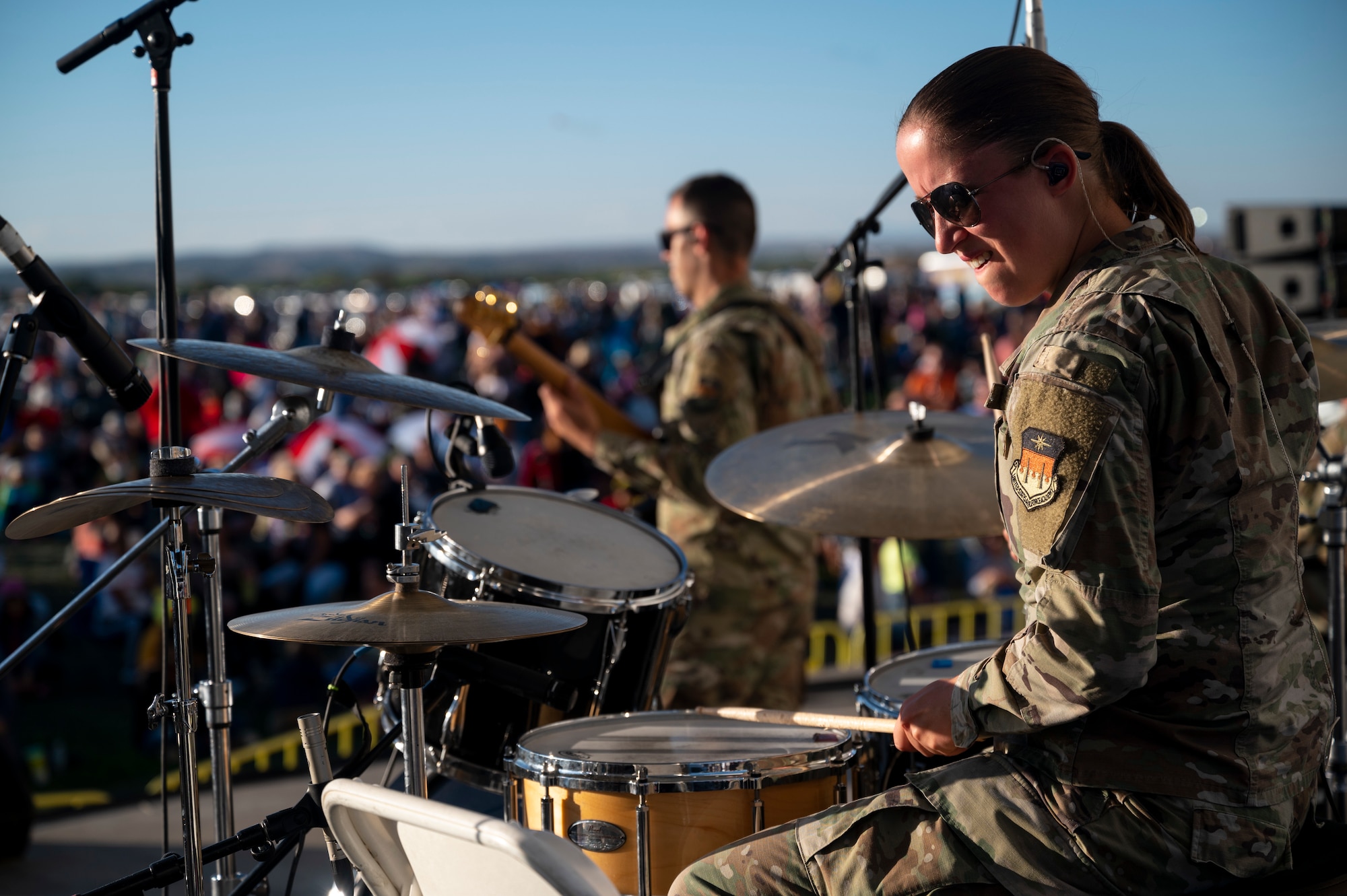 Tech. Sgt. Kathryn Yuill, Air Force Academy Band regional bandsman, plays the drums during the International Balloon Fiesta in Albuquerque, N.M., Oct. 7, 2023. The Albuquerque International Balloon Fiesta is held annually and draws in hundreds of thousands attendees each year. (U.S. Air Force photo by Airman 1st Class Ruben Garibay.)