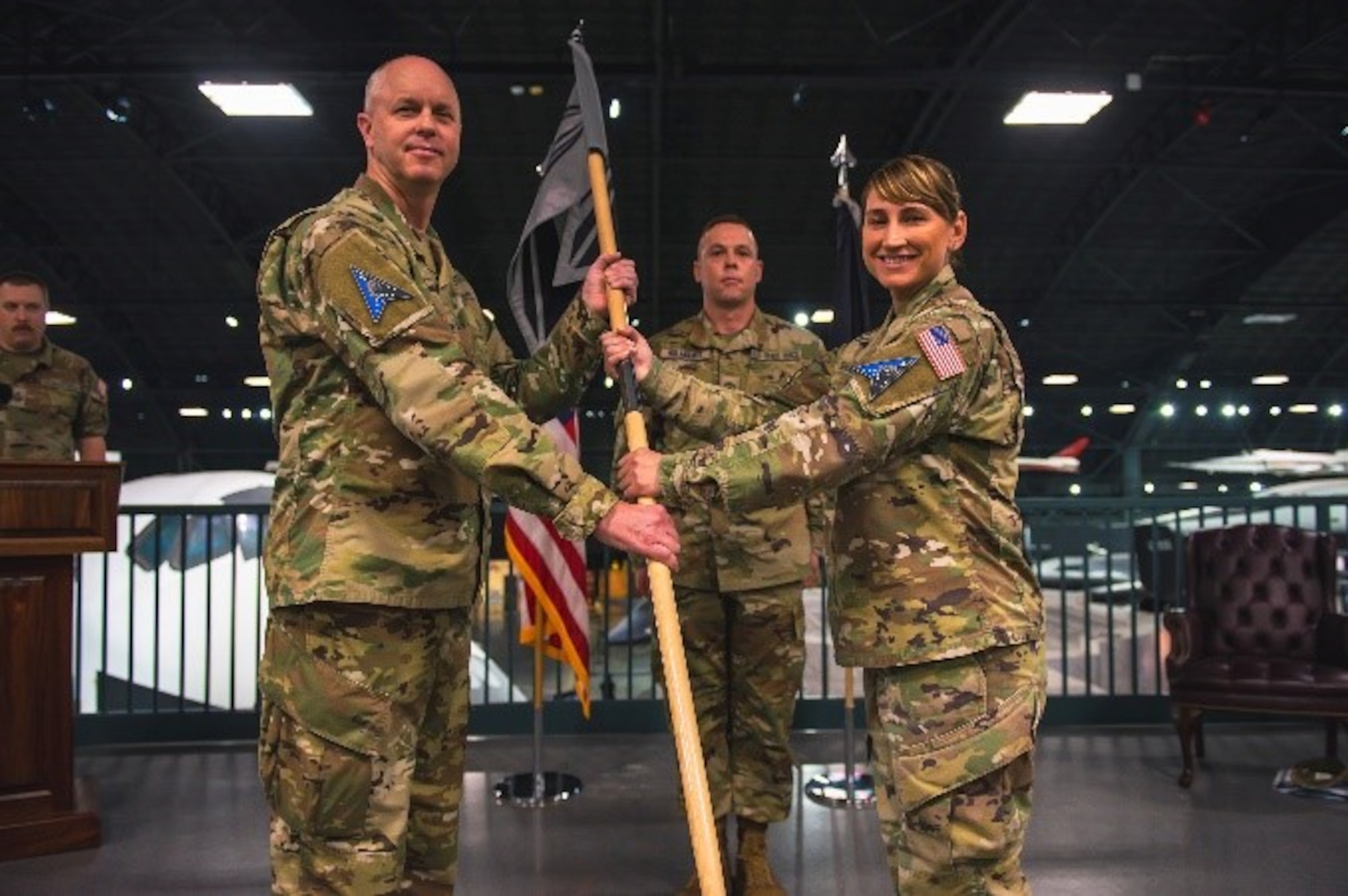 Military members pose for a photo during an activation ceremony.