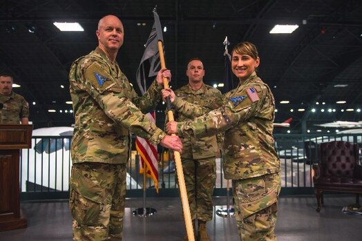  Military members pose for a photo during an activation ceremony.