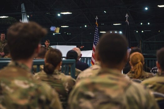  Military members listening to a speech during an activation ceremony.