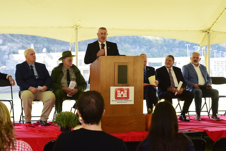 Wesley Butler, Hydropower Plant superintendent, talks about the importance of hydroelectricity to the region and efforts over the past 50 years to maintain aging equipment to provide reliable energy during the Cordell Hull Dam 50th Anniversary Celebration Oct. 7, 2023, on the shoreline below the dam in Elmwood, Tennessee. (USACE Photo by Lee Roberts)