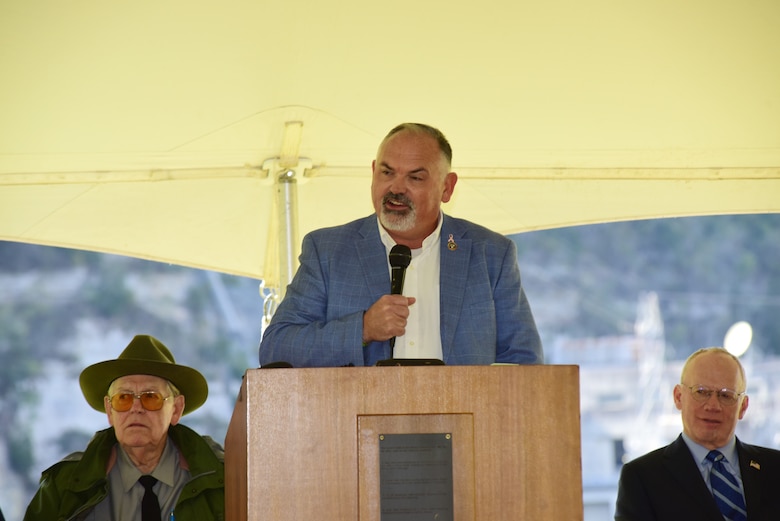 Smith County Mayor Jeff Mason shares how his father worked to construct Cordell Hull Dam and how the dam always reminds him of his daddy while addressing guests during the Cordell Hull Dam 50th Anniversary Celebration Oct. 7, 2023, on the shoreline below the dam in Elmwood, Tennessee. (USACE Photo by Lee Roberts)