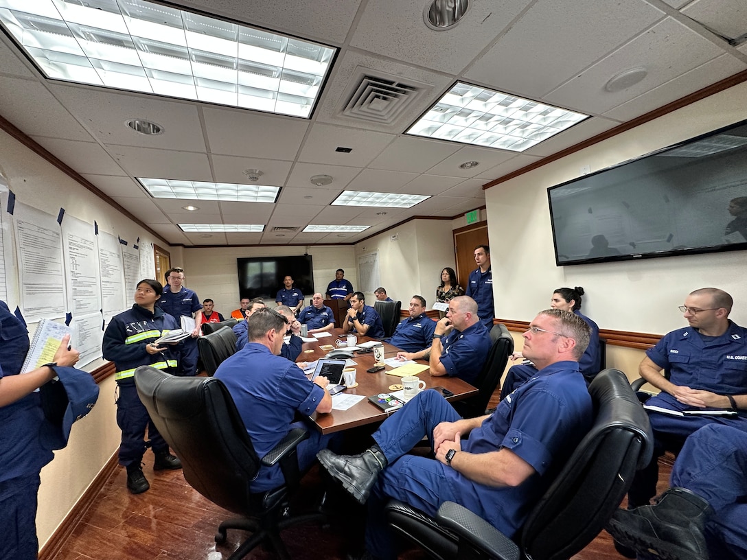 Lt. j.g. Deb King leads an incident management team meeting at U.S. Coast Guard Forces Micronesia/Sector Guam on Oct. 11, 2023, as the assembled team discusses steps to address the impacts of Typhoon Bolaven. The group included members of FM/SG, Base Guam, DOL-X, USCGC Hickory (WLB 212), and U.S. Coast Guard District 14. (U.S. Coast Guard photo by Chief Warrant Officer Sara Muir)