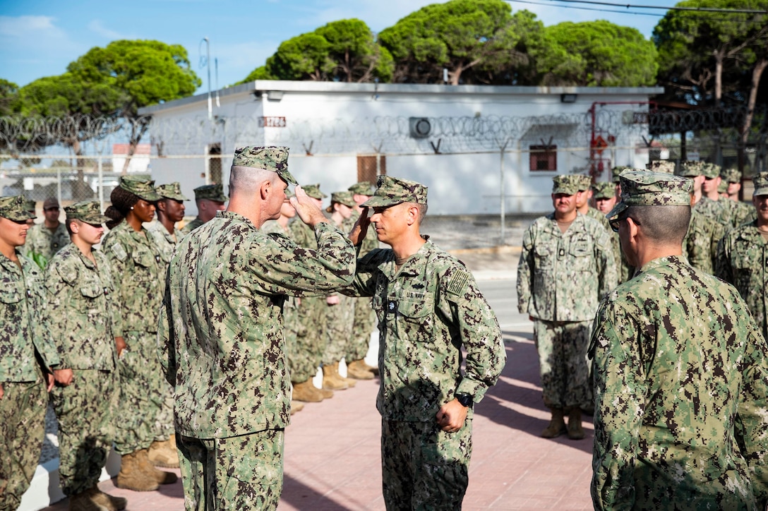 Cmdr. Daniel Schmitt, left, commaning officer of Naval Mobile Construction Battalion 1 (NMCB 1), and Cmdr. Christopher Archer, commanding officer of Naval Mobile Construction Battalion 133, turn over command of Camp Mitchell in Rota, Spain, September 1, 2023.