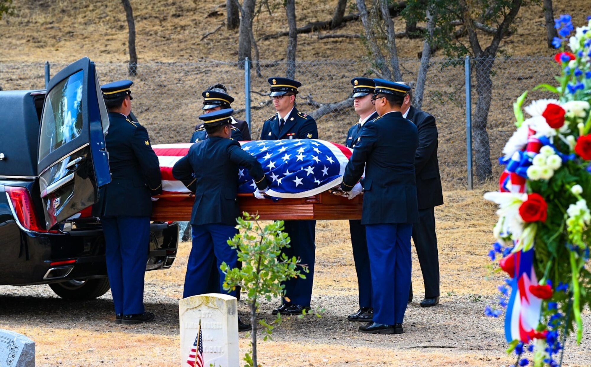 U.S. Army honor guardsmen carry a casket.