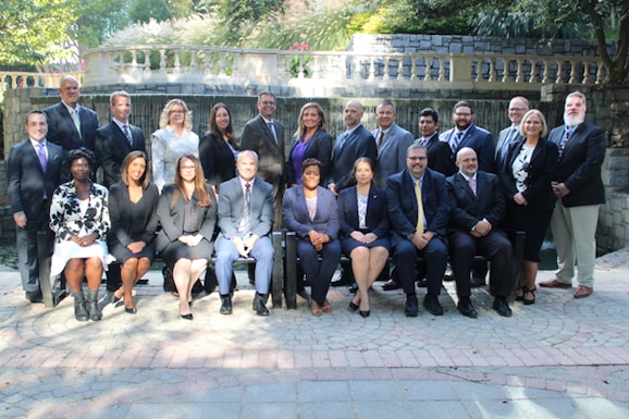 Group of professionals posing for camera.