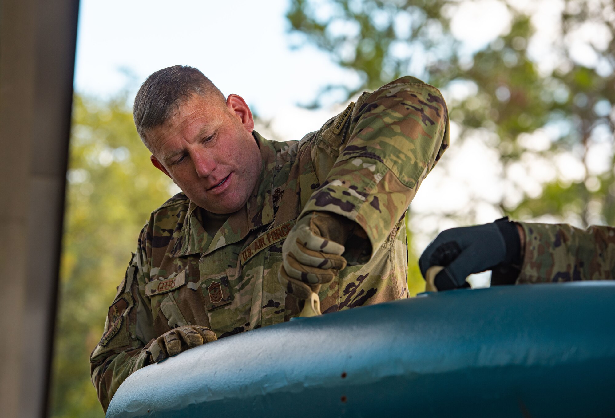 U.S. Air Force Chief Master Sgt. Justin Geers, 23rd Wing command chief inspects a BDU-50 practice ordinance at Moody Air Force Base, Georgia, Oct. 2, 2023. During a wing leadership visit, Airmen directed leadership on how to properly prepare munitions for assembly. (U.S. Air Force Airman 1st Class Sir Wyrick)