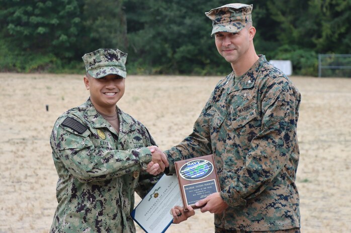 BANGOR, Wash. (August 18, 2023) - Master-at-Arms 1st Class Jerel F. Laya is presented with the FY2022 Strategic Systems Programs Sailor of the Year Award by LtCol Ian Dunlap, Commanding Officer, Marine Corps Security Force Battalion, Bangor. Sailor of the Year candidates represent the highest performers of the entire Strategic Systems Programs enterprise. Laya’s contributions directly supported SSP’s mission of executing Naval Nuclear Weapons Program Technical Authority for Department of the Navy nuclear weapons and Nuclear Weapons systems, as well as its regulatory oversight of the Navy Nuclear Deterrence Mission. MAs supporting the SSP mission at Bangor are integrated into the MCSFBn as an integral part of the multi-layered capabilities ensuring the nuclear weapons and nuclear weapons systems security at Strategic Weapons Facility Pacific. Approximately 10 percent of the Navy’s MA force supports the SSP mission between the two SWFs.