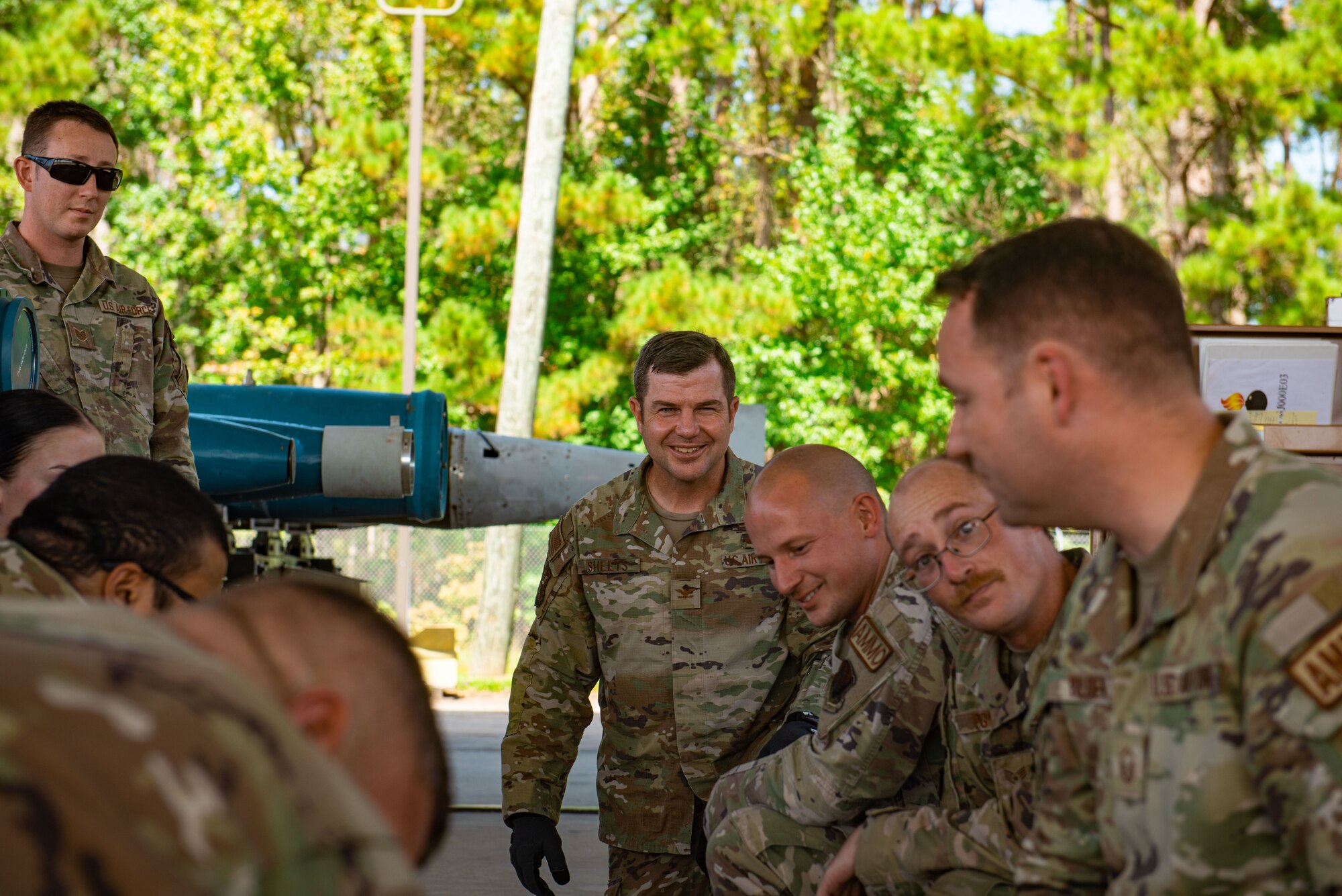 U.S. Air Force Airmen discuss a potential problem with a conical fin at Moody Air Force Base, Georgia, Oct. 2, 2023. Before assembly Airmen are to carefully inspect equipment to reduce chances of assembly failure. (U.S. Air Force Airman 1st Class Sir Wyrick)