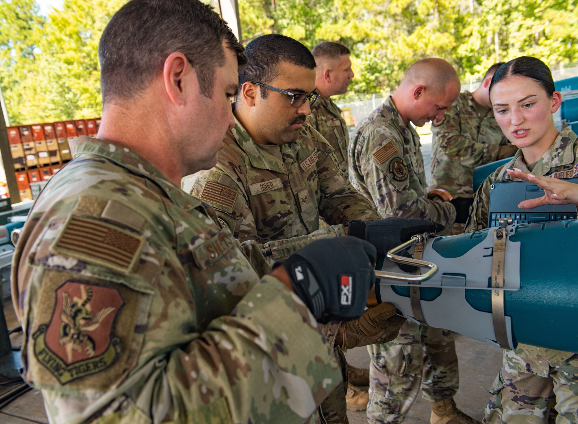 U.S. Air Force Col. Paul Sheets, 23rd Wing commander, tightens a clasp on a practice munition at Moody Air Force Base, Georgia, Oct. 2, 2023. Assembly of the munitions starts by placing and tightening the nose plugs. (U.S. Air Force Airman 1st Class Sir Wyrick)