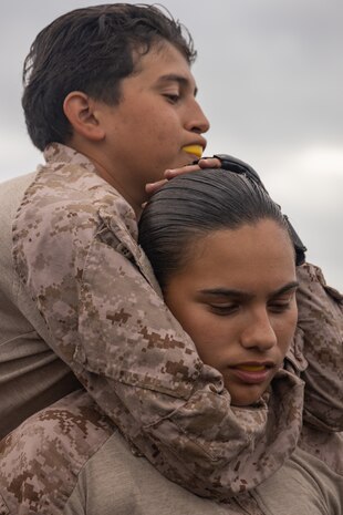 U.S. Marine Corps Recruit Angelina Gulick, left, and Priscilla Ramirez, right, with Fox Company, 3rd Recruit Training Battalion, execute a rear choke during a Marine Corps Martial Arts Program training event at Marine Corps Recruit Depot San Diego, Oct. 10, 2023. MCMAP aims to strengthen the mental and moral resiliency of individual recruits and Marines through realistic combative training, warrior ethos studies and physical hardening. Gulick is native of Greenfield, Calif. Ramirez is native of Fort Wayne, Ind. (U.S. Marine Corps photo by Lance Cpl. Janell B. Alvarez)