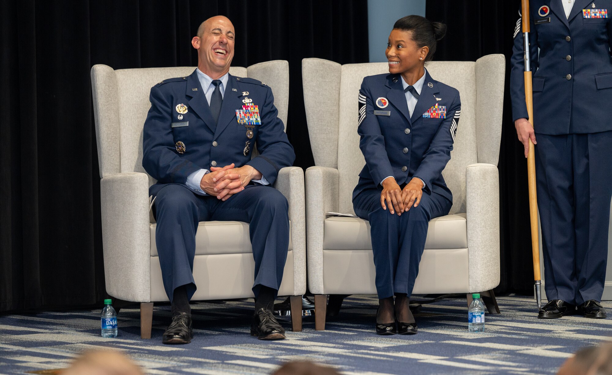 Two Airmen sit and talk