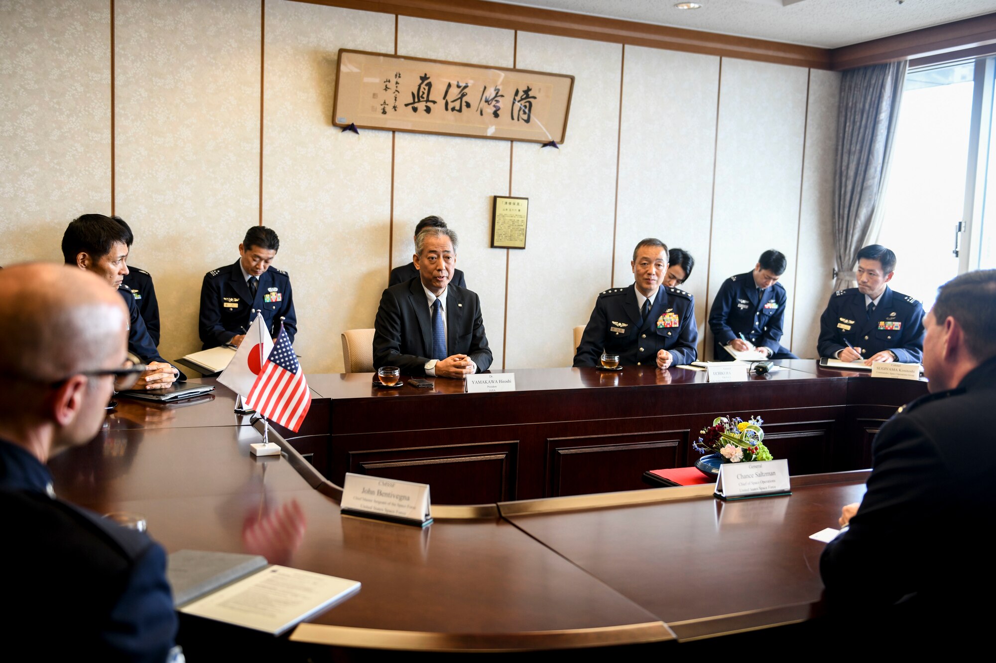 People sit around a table for a meeting.