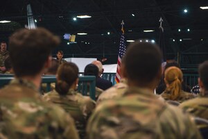 Service members listen to a speech