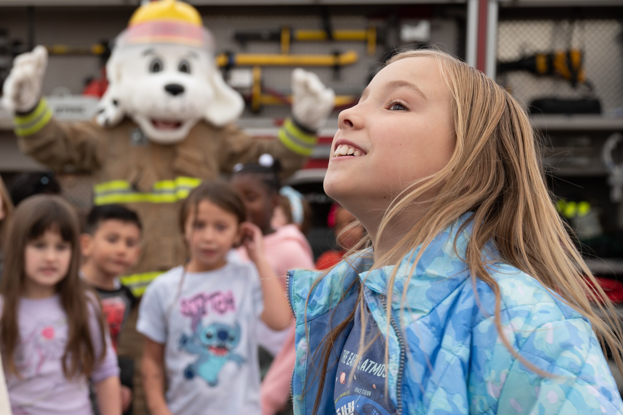 Children pose with  Sparky, the 673d Civil Engineer Squadron fire dog mascot