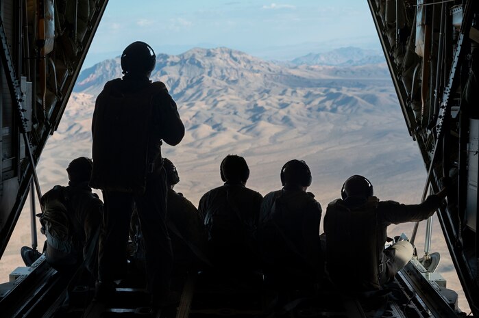 U.S. Air Force Airmen from the 34th Weapons Squadron gaze out the back of a C-130J Combat King II over Las Vegas, Nevada, Oct. 9, 2023.