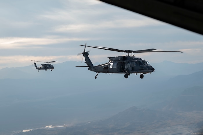 HH-60W Jolly Green IIs wait to join formation for a flyover over Allegiant Stadium, Las Vegas, Nevada, Oct. 9, 2023.