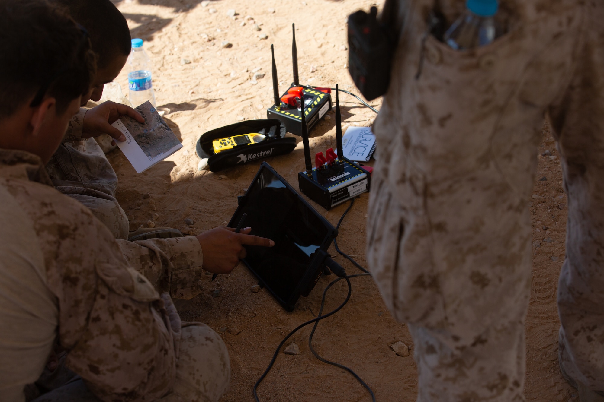 U.S. Marine members pilot an UAV from a tablet