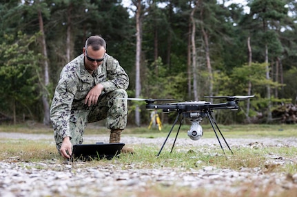 Utilitiesman 1st Class Christopher Boughton, assigned to Naval Mobile Construction Battalion 133 (NMCB 133), operates a drone for a boat ramp survey in Bornholm, Denmark, Sept. 22, 2023.