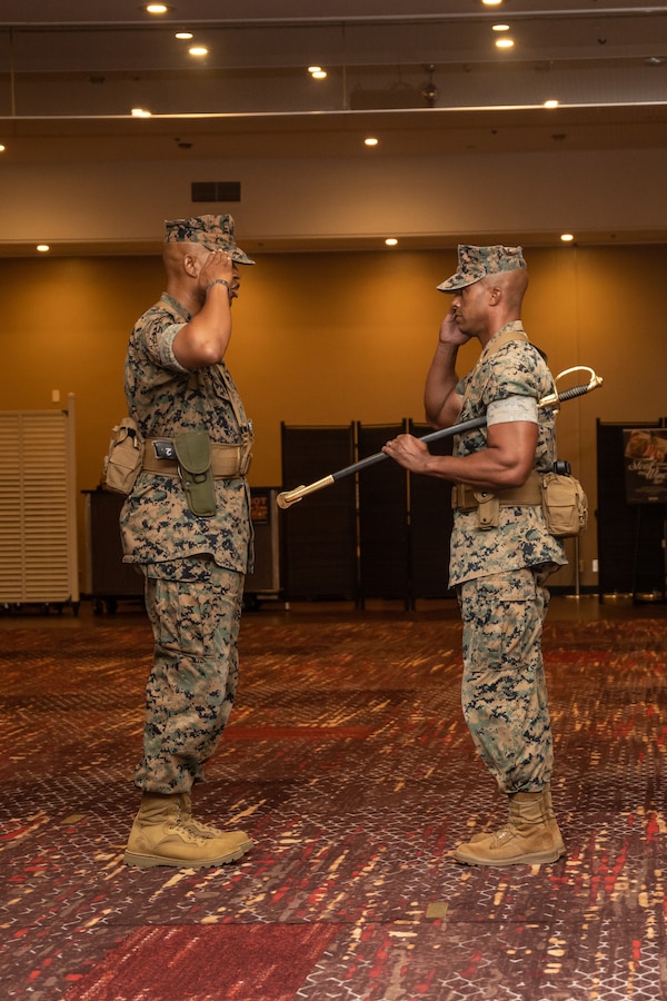 U.S. Marine Corps Sgt. Maj. Imhotep Woodby, left, oncoming Combat Logistics Regiment 37 (CLR-37), 3rd Marine Logistics Group (MLG) sergeant major, salutes Col. Andre Ingram, right, commanding officer of CLR-37, during an appointment ceremony at Camp Kinser, Okinawa, Japan, Sept. 28, 2023. During the ceremony, Sgt. Maj. Woodby assumed the position as sergeant major of CLR-37. 3rd MLG, based out of Okinawa, Japan, is a forward-deployed combat unit that serves as III Marine Expeditionary Force’s comprehensive logistics and combat service support backbone for operations throughout the Indo-Pacific area of responsibility. (U.S. Marine Corps photo by Cpl. Sydni Jessee)