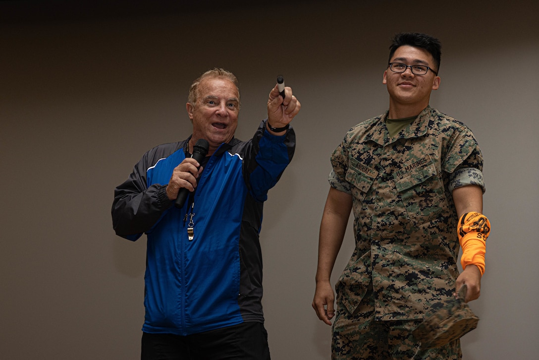 Steve Verret, left, a professional driving-safety educator, presents traffic safety education to the U.S. Marines with III Marine Expeditionary Force in order to promote safe driving, at Camp Kinser, Okinawa, Japan, Sept. 14, 2023. Traffic safety education and safe driving practices are essential to ensuring III MEF Marines remain an operational force that is ready to “fight now.” (Marine Corps photo by LCpl. Weston Brown)