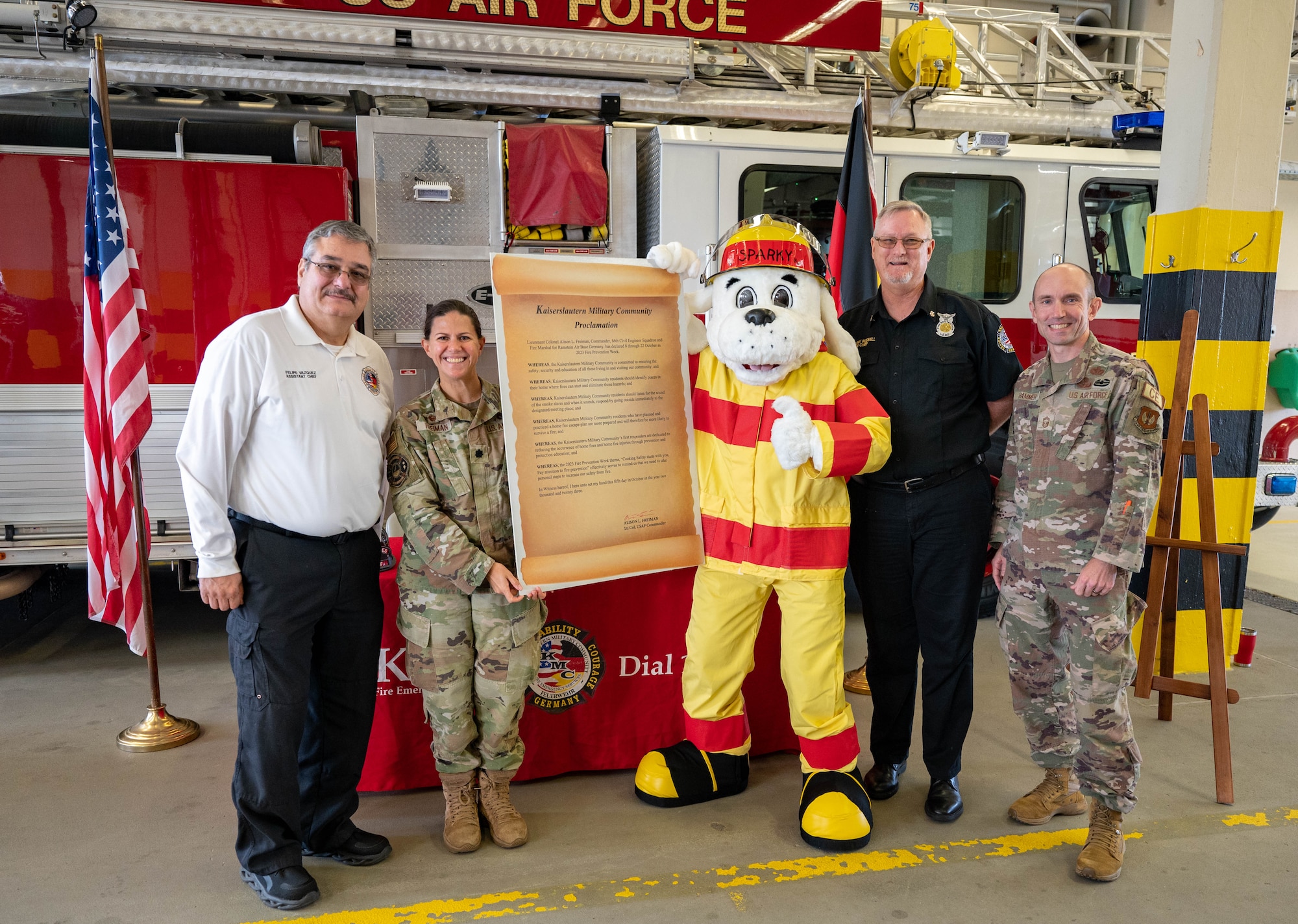 86th Civil Engineer Squadron leaders present the Kaiserslautern Military Community Proclamation poster.