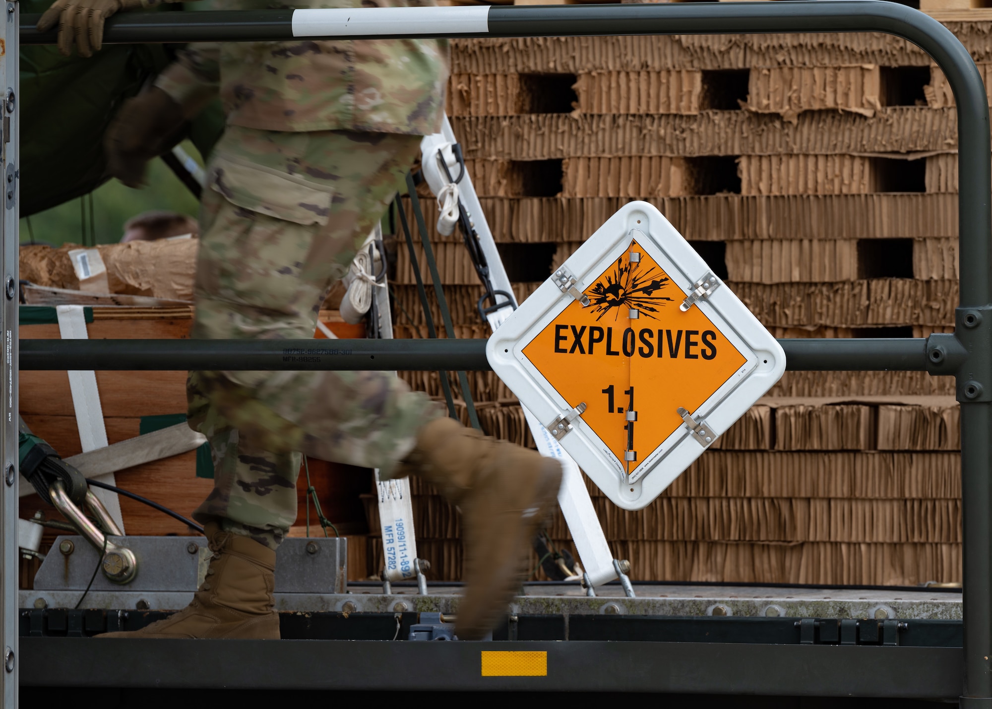 airman runs past cargo pallet containing live ammunitions