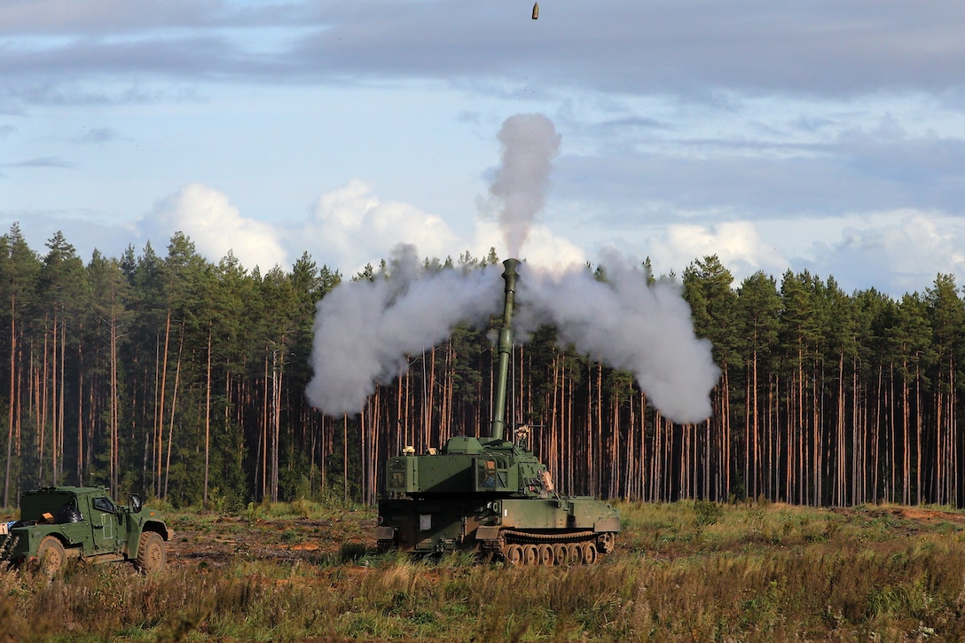 Smoke is shown in the air after a round is fired from a tank.