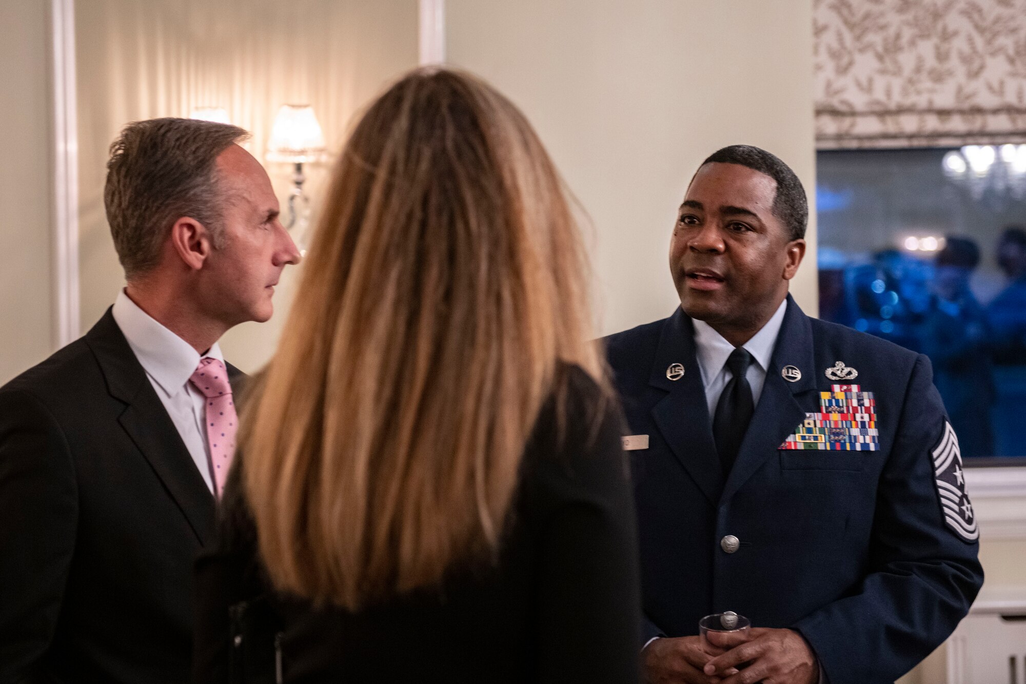 Chief Master Sgt. Terrance D. Boyd, 501st Combat Support Wing command chief, right, speaks with attendees during a local civic leader reception at RAF Alconbury
