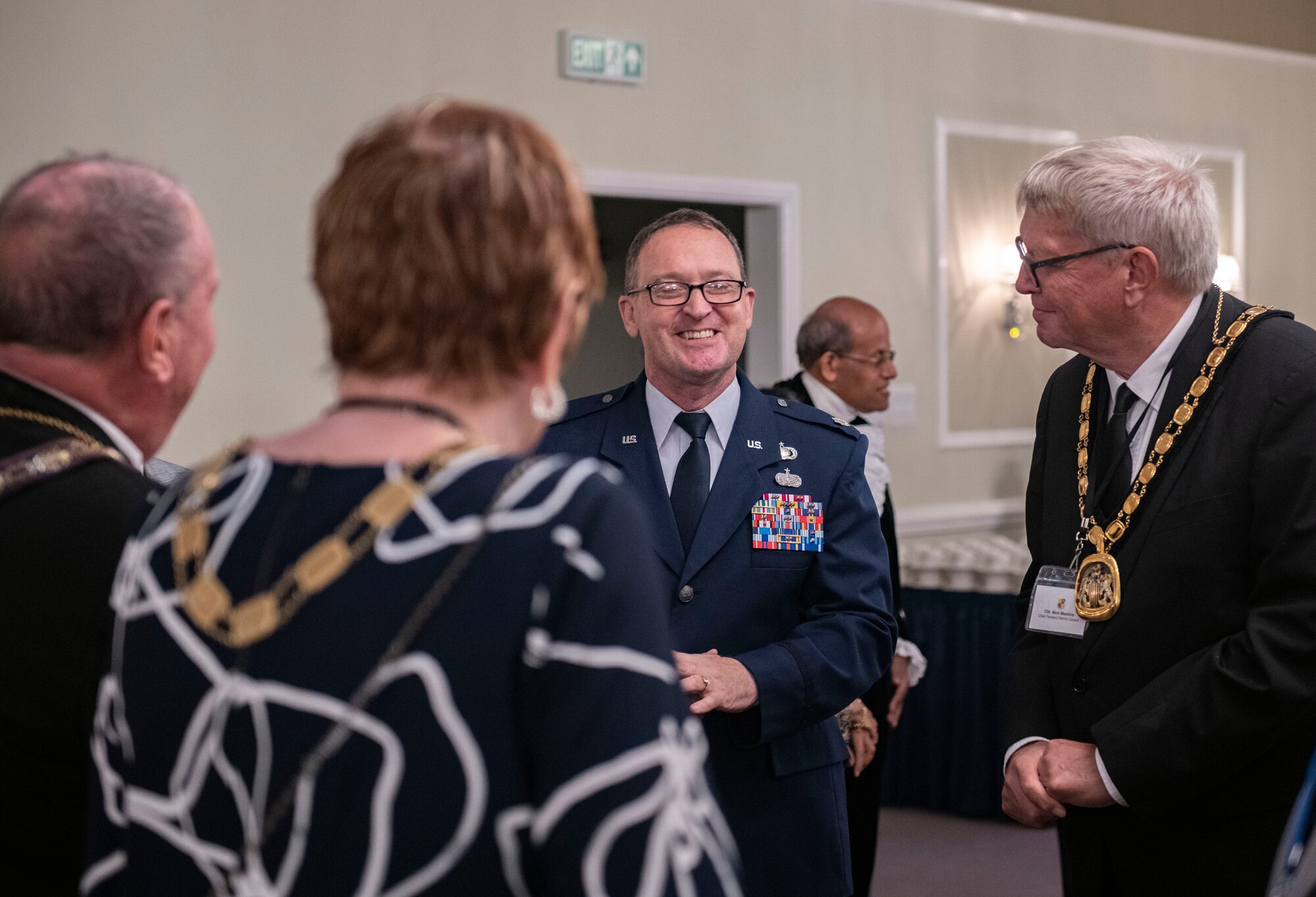 Lt. Col. Liam Clancy, 501st Combat Support Wing Director of Staff, center, speaks with attendees during a local civic leader reception at RAF Alconbury