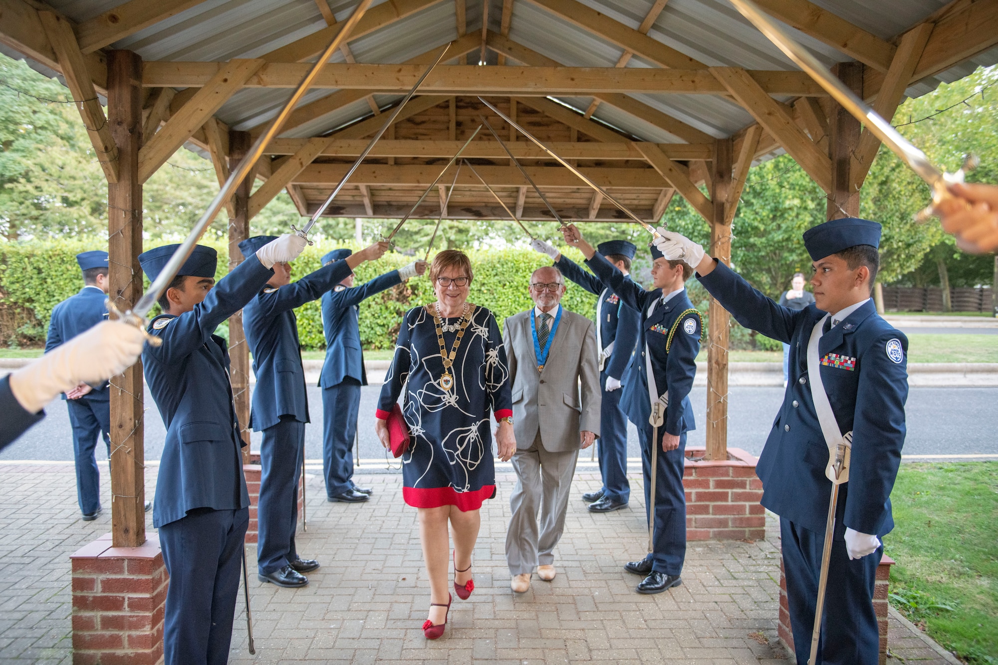 Members of the Alconbury Middle High School Junior Reserve Officers’ Training Corp provide a saber arch for attendees during a local civic leader reception at RAF Alconbury