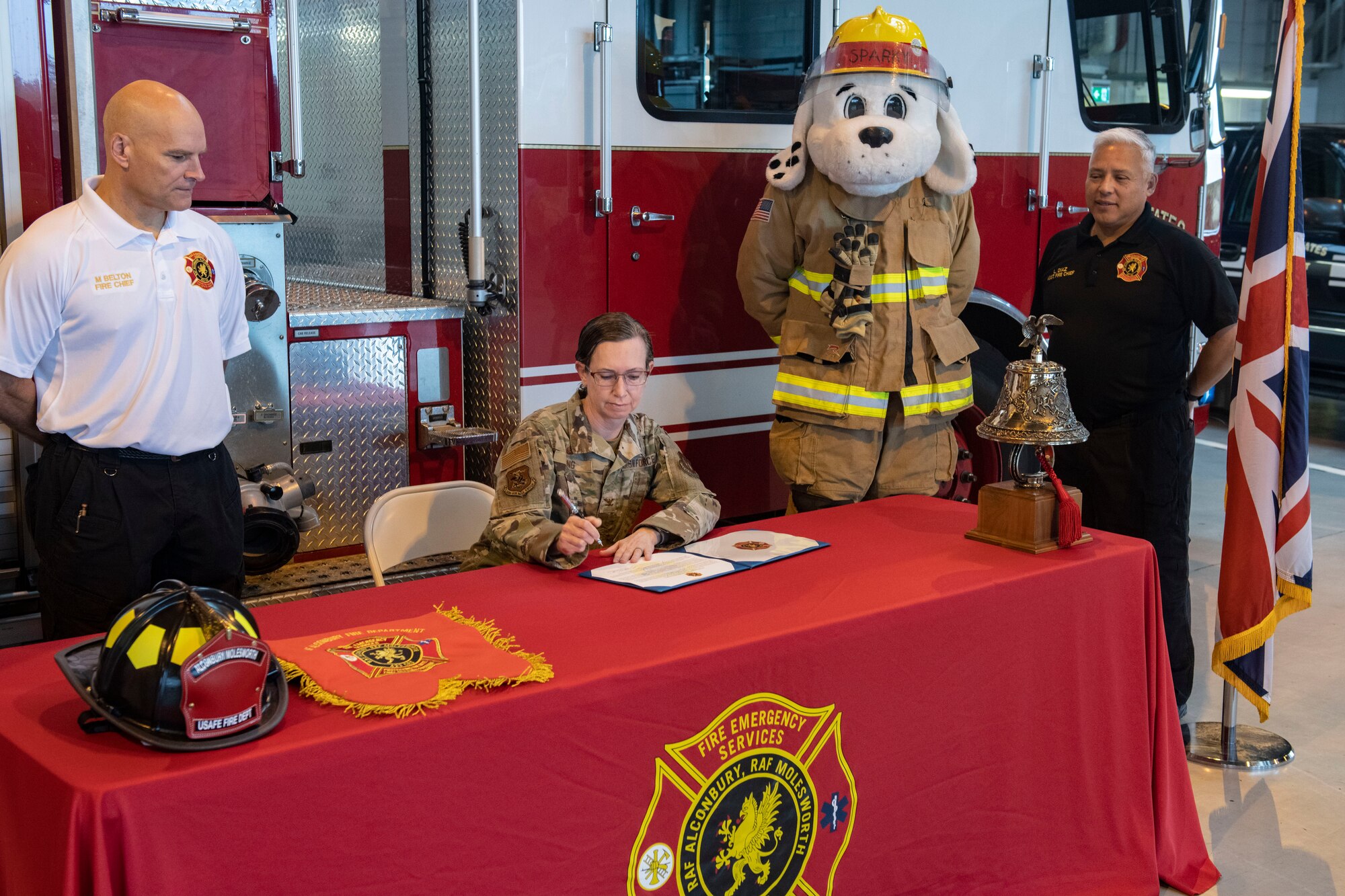 Col. Valarie A. Long, 423d Air Base Group Commander, center, signs the proclamation of Fire Prevention Week 2023 at RAF Alconbury