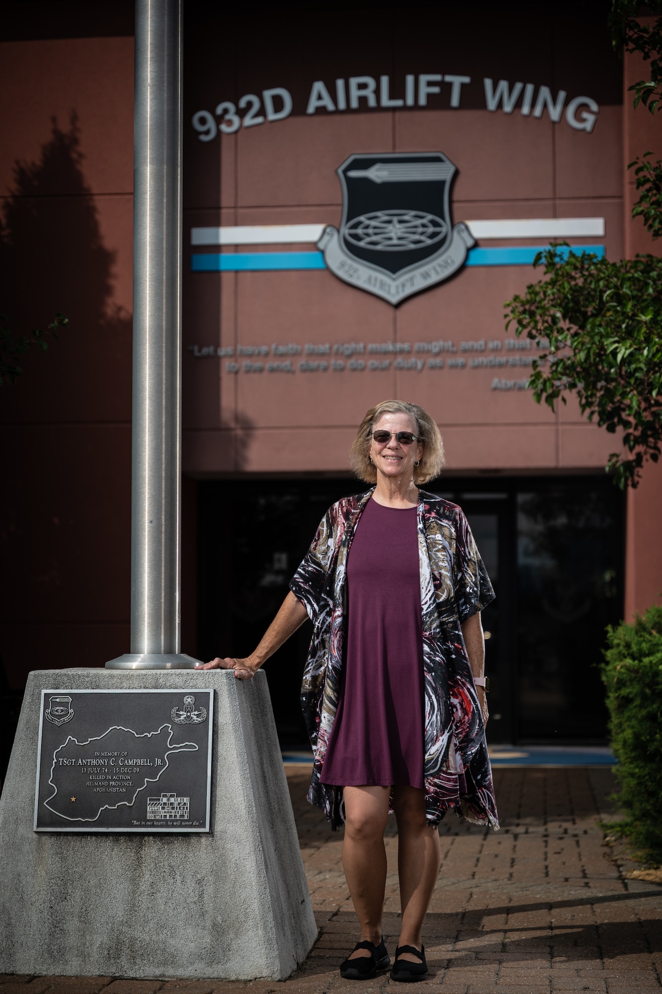 Deb Teague, 932nd Military and Family Readiness Center program manager, poses for a portrait in front of the 932nd Airlift Wing building and flag pole Sept. 28, 2023, Scott Air Force Base, Illinois.  retires (U.S. Air Force photo by Christopher Parr)