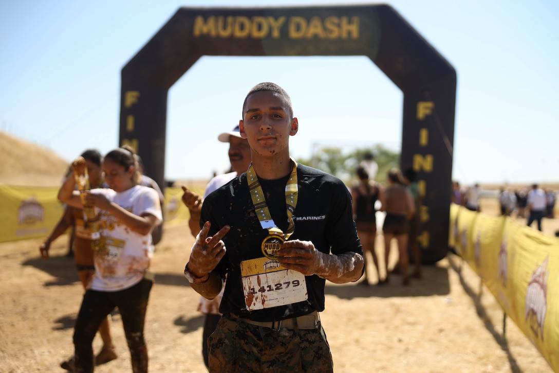 U.S. Marine Corps Pvt. Jesus Valencia poses for a photo after completing the Muddy Dash at the Sacramento Raceway in Sacramento, Calif. on Aug. 12, 2023. Pvt. Valencia was recruited out of Recruiting Substation Elk Grove, Recruiting Station Sacramento, and attended the Muddy Dash to interact with the community. (U.S. Marine Corps photo by Sgt. Seaira Moore)