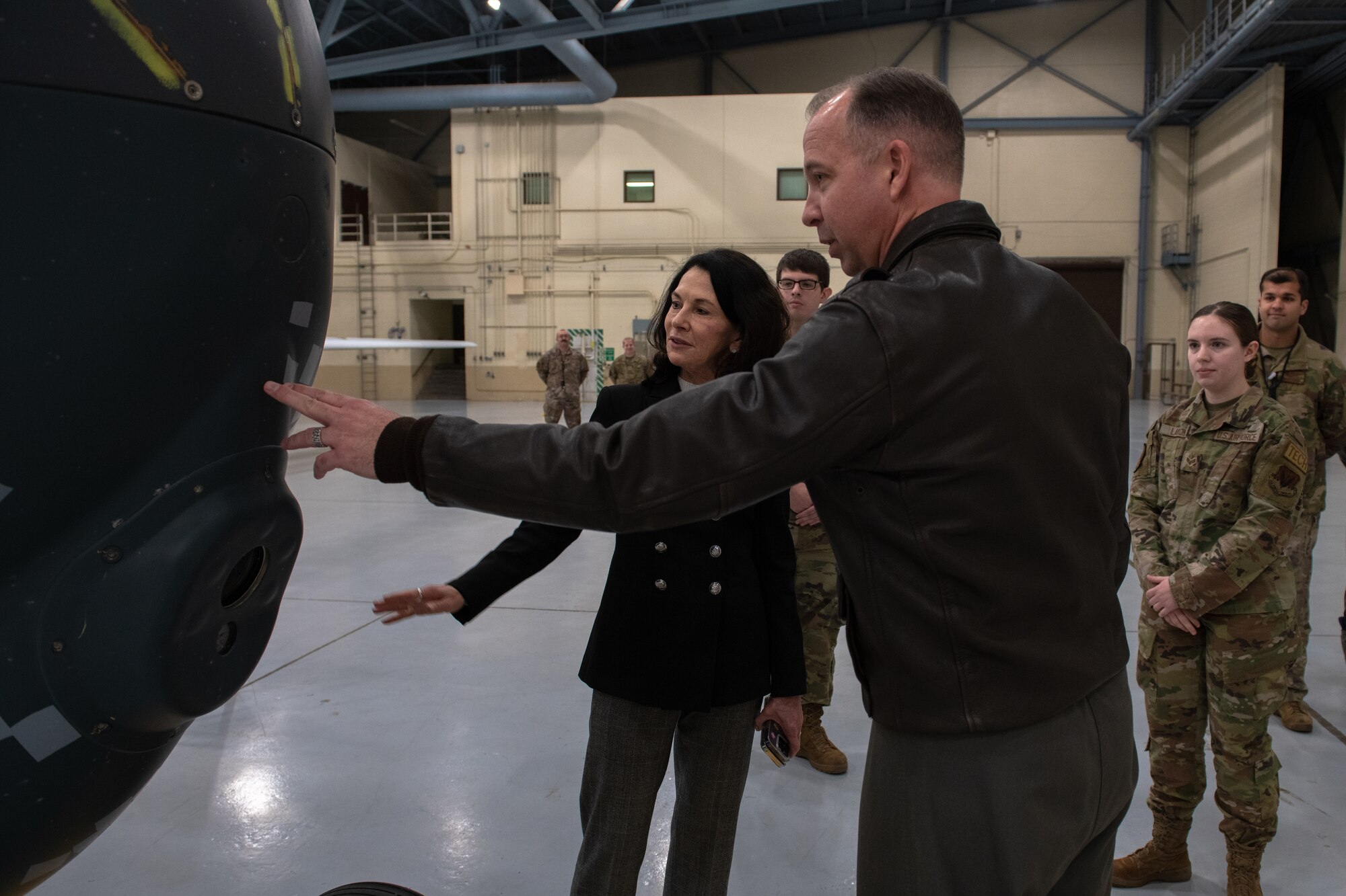 Man and Woman touch air craft wall.